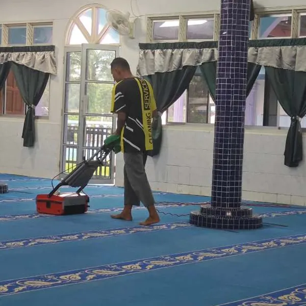 Mesin ekstraksi digerakkan sepanjang karpet dewan solat
